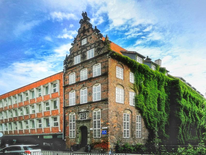 Siedziba Muzeum Uniwersytetu Gdańskiego - zabytkowa gdańska kamienica na tle błękitnego nieba.